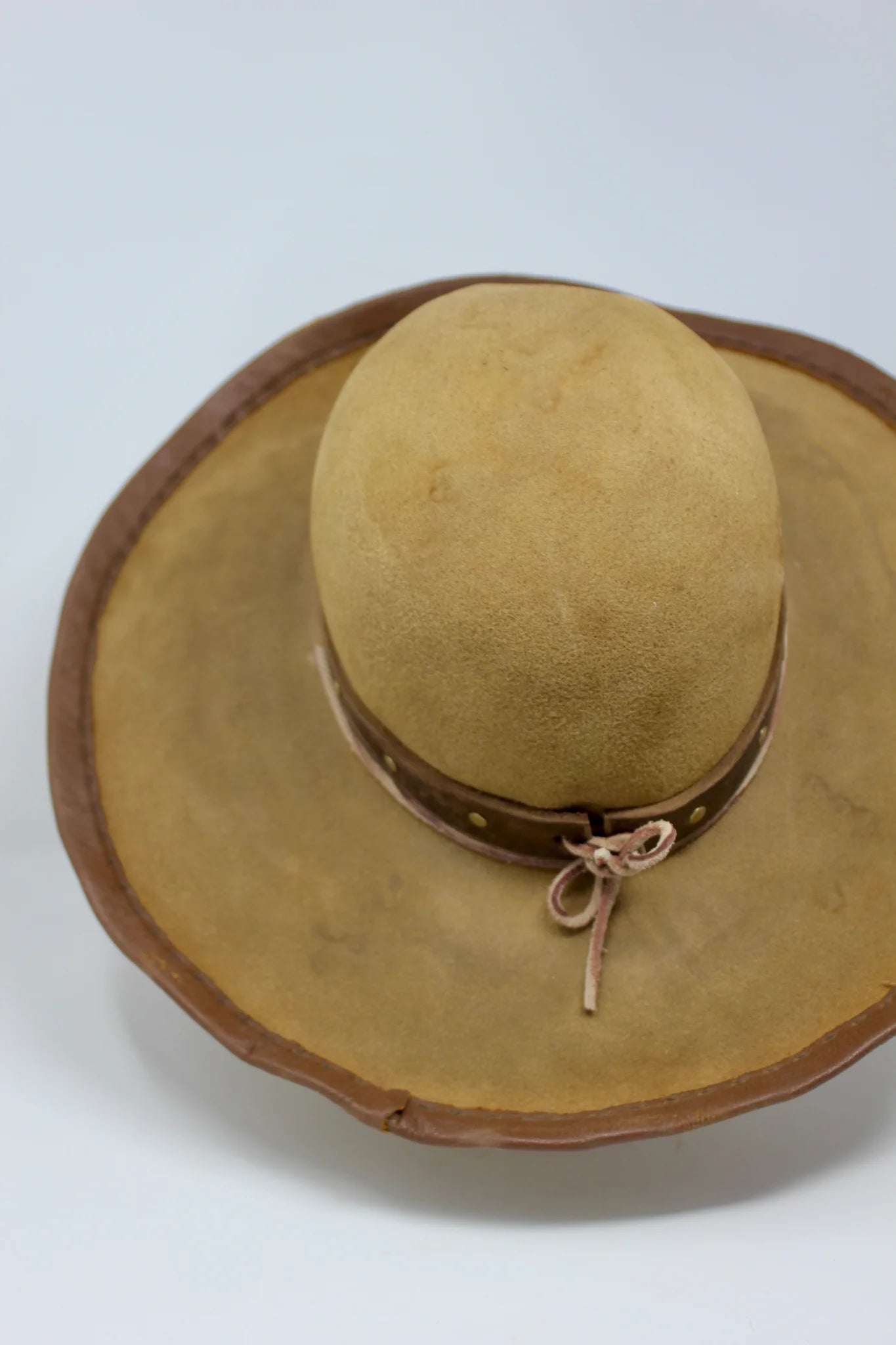 partial top view of the Handmade wide brim hat inspired by Elsa “Lightning with the Yellow Hair” from the 1883 series with leather band, studs, and stampede strap.
