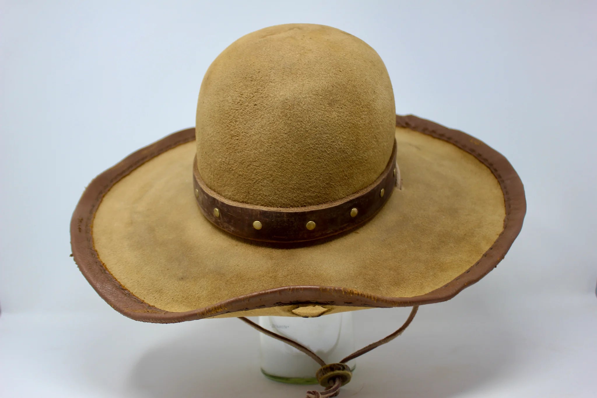 Handmade wide brim hat inspired by Elsa “Lightning with the Yellow Hair” from the 1883 series with leather band, studs, and stampede strap.