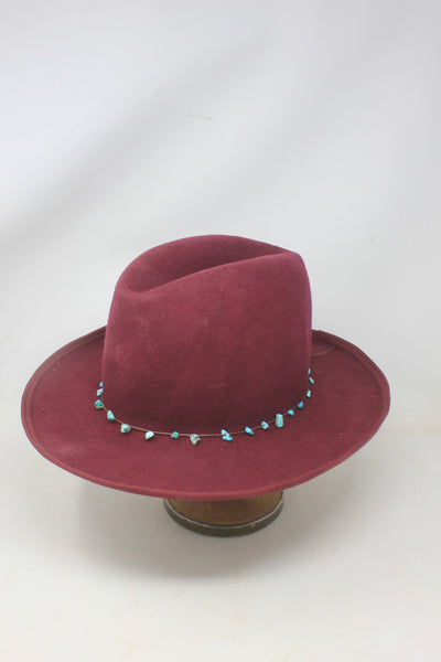 Left View of the LH Bordeaux Crease hat by Lone Hawk Hats featuring bordeaux fur blend felt, a slight crease crown, and a hand-tied turquoise band, size 7 1/4.
