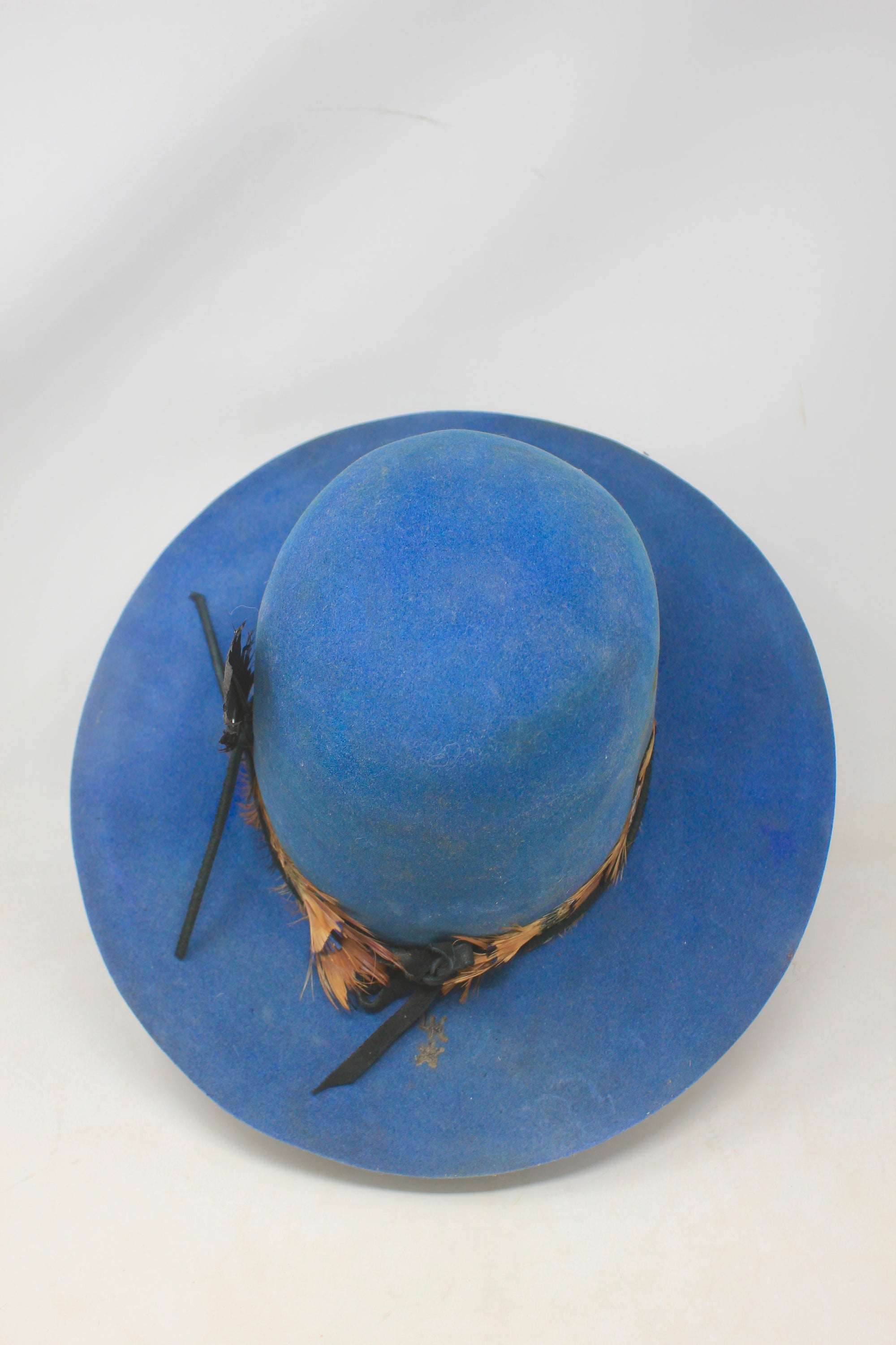 Top view of the LH Open Crown Feather Band hat by Lone Hawk Hats featuring royal blue fur blend felt, an open crown, medium brim, and handmade feather banding.