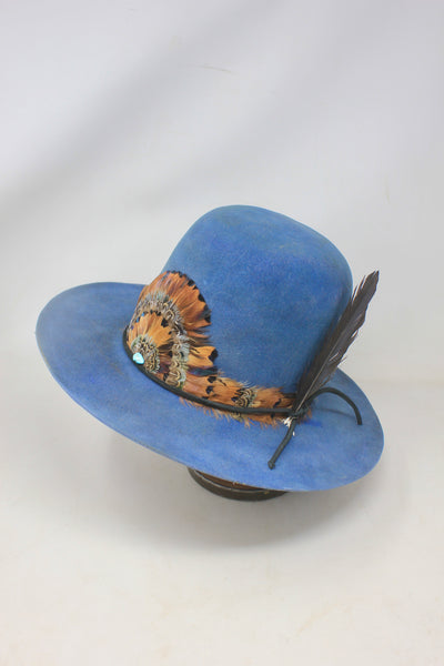 Left view of the LH Open Crown Feather Band hat by Lone Hawk Hats featuring royal blue fur blend felt, an open crown, medium brim, and handmade feather banding.
