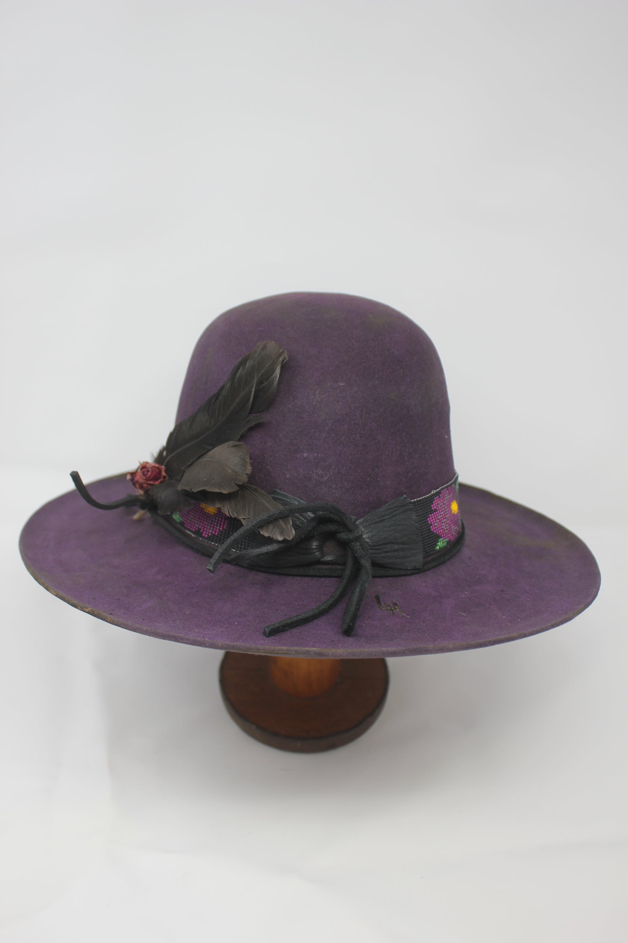 back view of the Plum Crazy hat by Lone Hawk Hats featuring hand-dyed purple vintage beaver felt, an open crown, and a hand-beaded floral band.