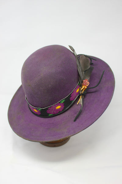 Plum Crazy hat by Lone Hawk Hats featuring hand-dyed purple vintage beaver felt, an open crown, and a hand-beaded floral band.
