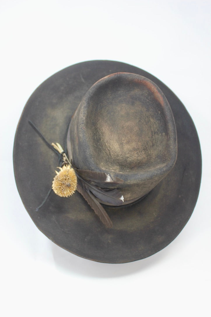 The Kid by Lone Hawk Hats, a handmade black beaver blend hat featuring hand distressing, a stitched band, and a found feather accent.