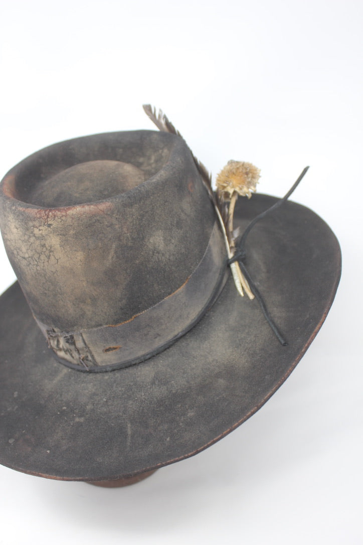 The Kid by Lone Hawk Hats, a handmade black beaver blend hat featuring hand distressing, a stitched band, and a found feather accent.