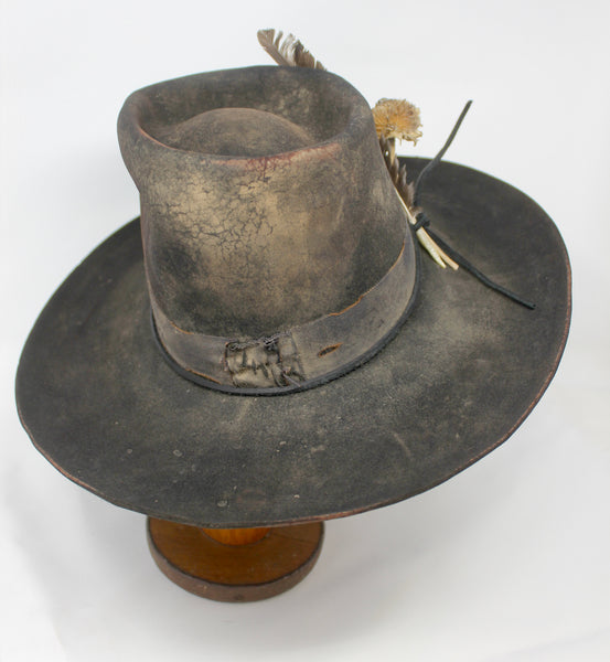 front view of The Kid by Lone Hawk Hats, a handmade black beaver blend hat featuring hand distressing, a stitched band, and a found feather accent.