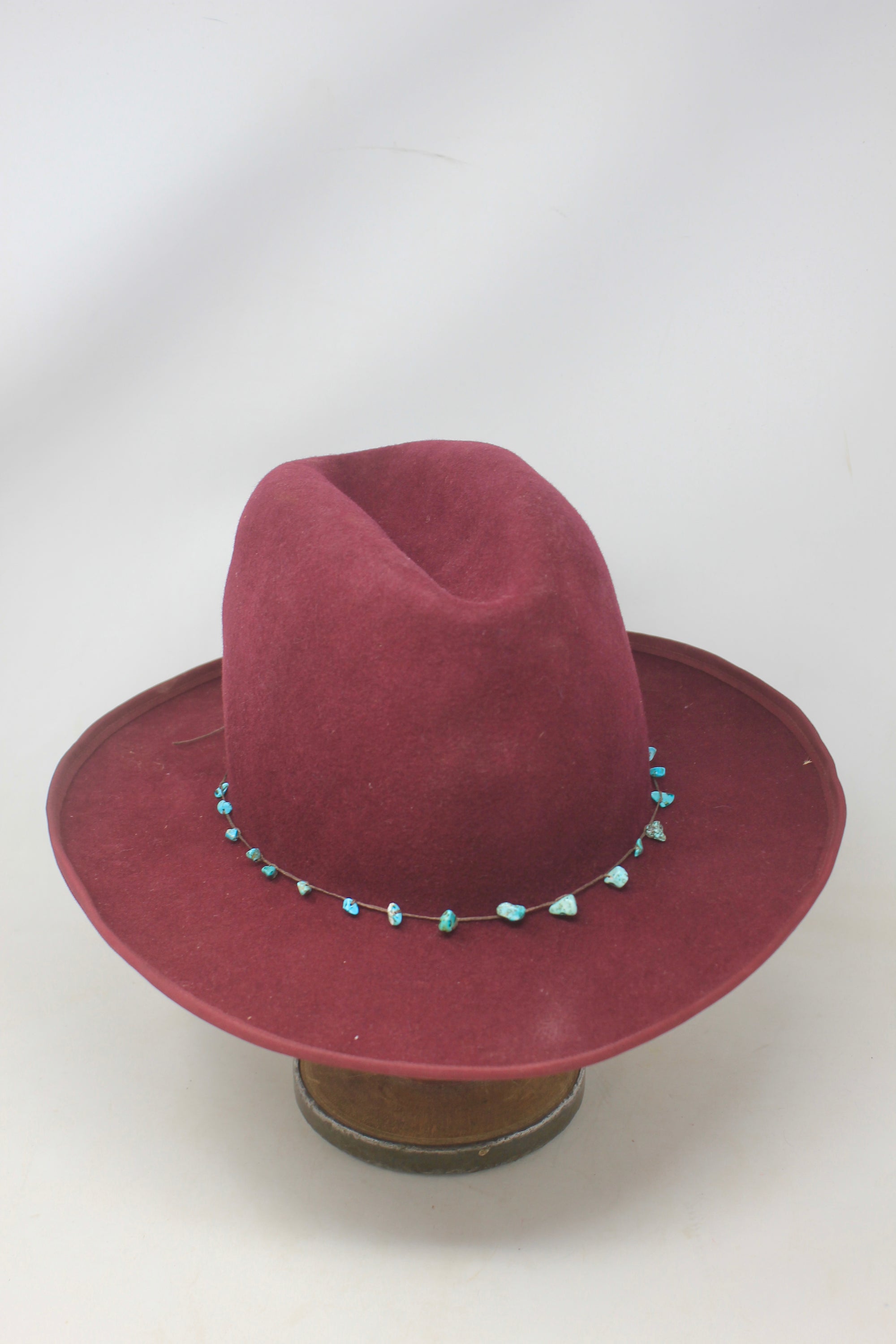 front view of the LH Bordeaux Crease hat by Lone Hawk Hats featuring bordeaux fur blend felt, a slight crease crown, and a hand-tied turquoise band, size 7 1/4.