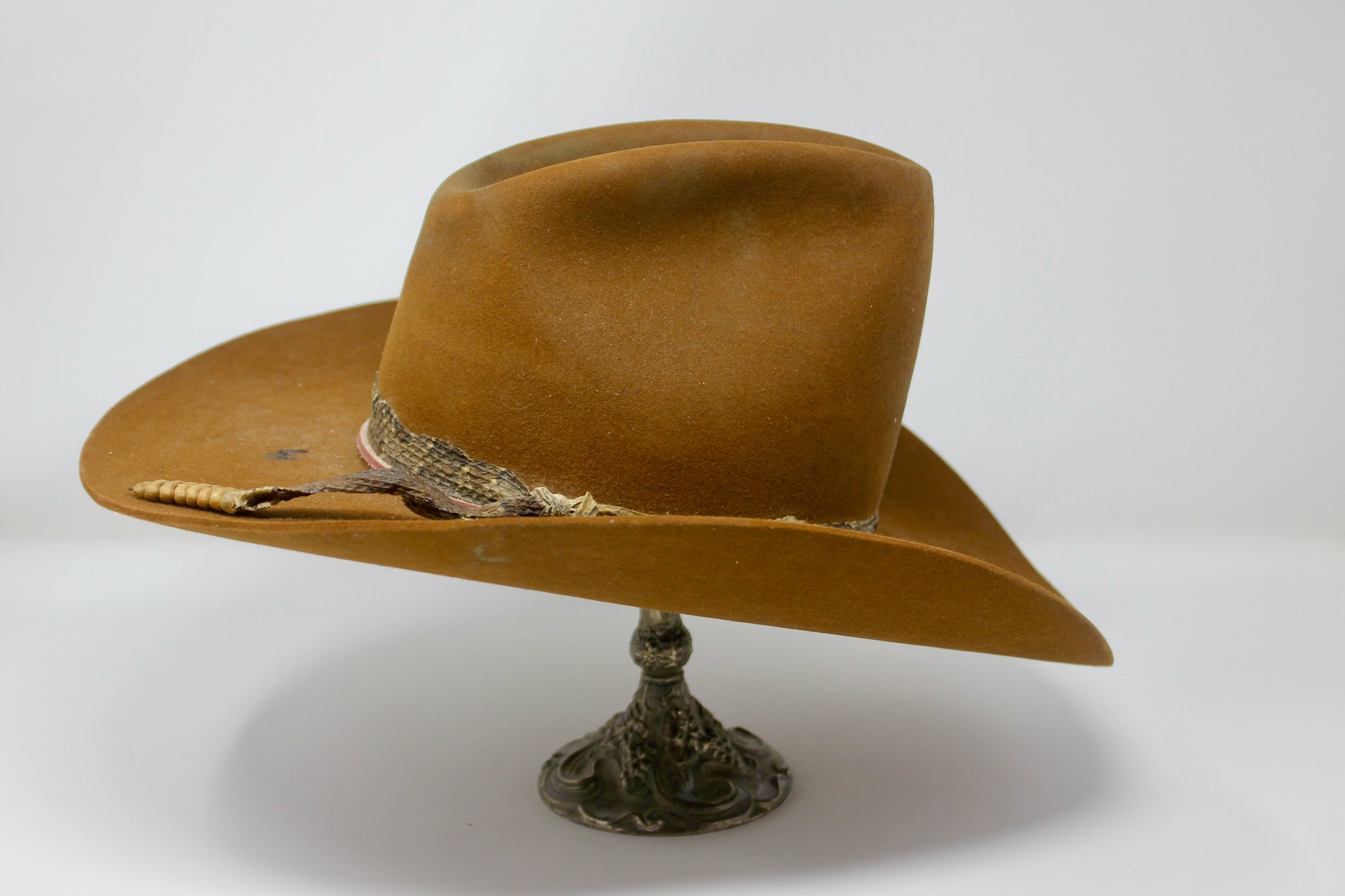 Right view of The HighHawk Snake Bite hat by Lone Hawk Hats featuring chestnut beaver felt, an authentic vintage snakeskin band, and a classic hi-low crown.