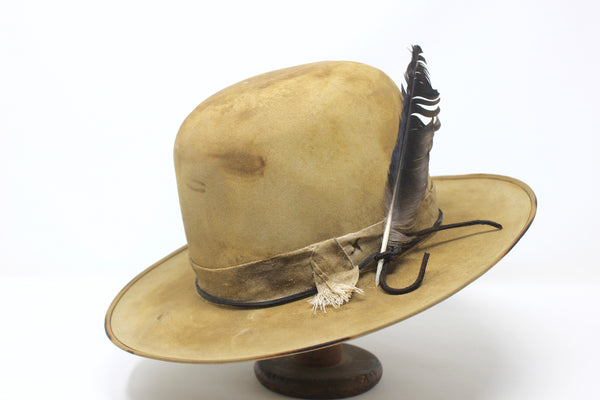 Left view of the Desert Hawk hat by Lone Hawk Hats featuring a fully distressed Dust Bowl-era style, tall open crown, flat brim, and hand-sewn band.