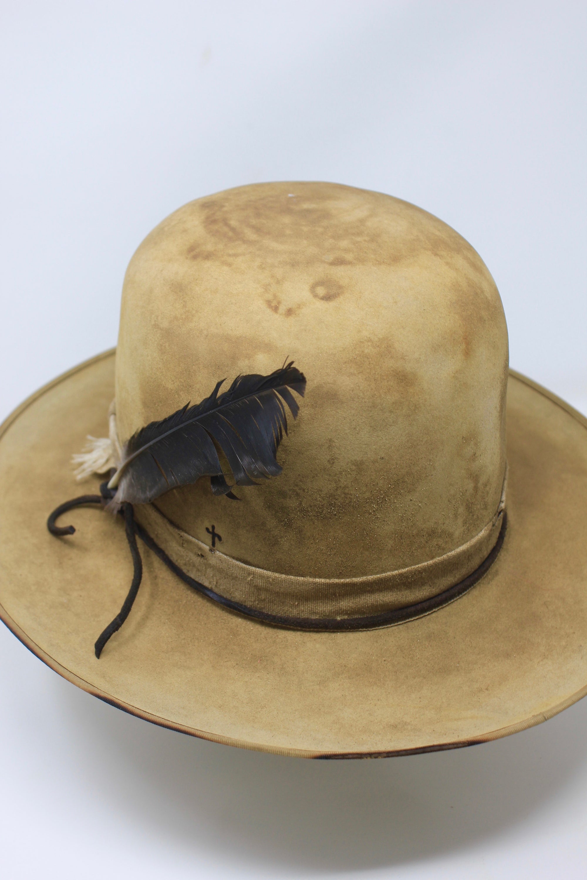 Partial Back view of the Desert Hawk hat by Lone Hawk Hats featuring a fully distressed Dust Bowl-era style, tall open crown, flat brim, and hand-sewn band.