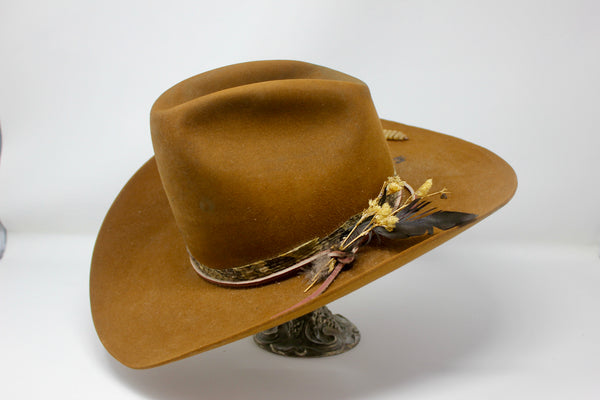 left view of The HighHawk Snake Bite hat by Lone Hawk Hats featuring chestnut beaver felt, an authentic vintage snakeskin band, and a classic hi-low crown.