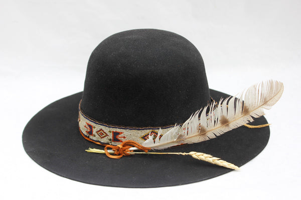 Left view of The Lady Starr by Lone Hawk Hats, a one-of-a-kind open crown western hat featuring an antique Native American hand-beaded band, flat brim, and found feather.