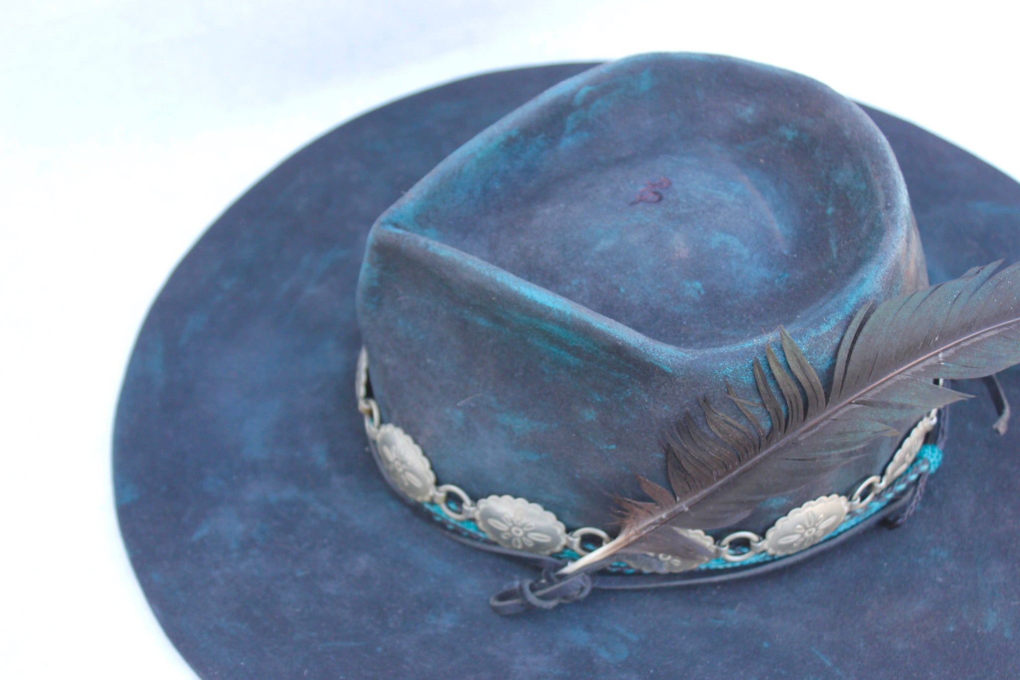 close up top view of the Plum Crazy hat by Lone Hawk Hats featuring hand-dyed purple vintage beaver felt, an open crown, and a hand-beaded floral band.