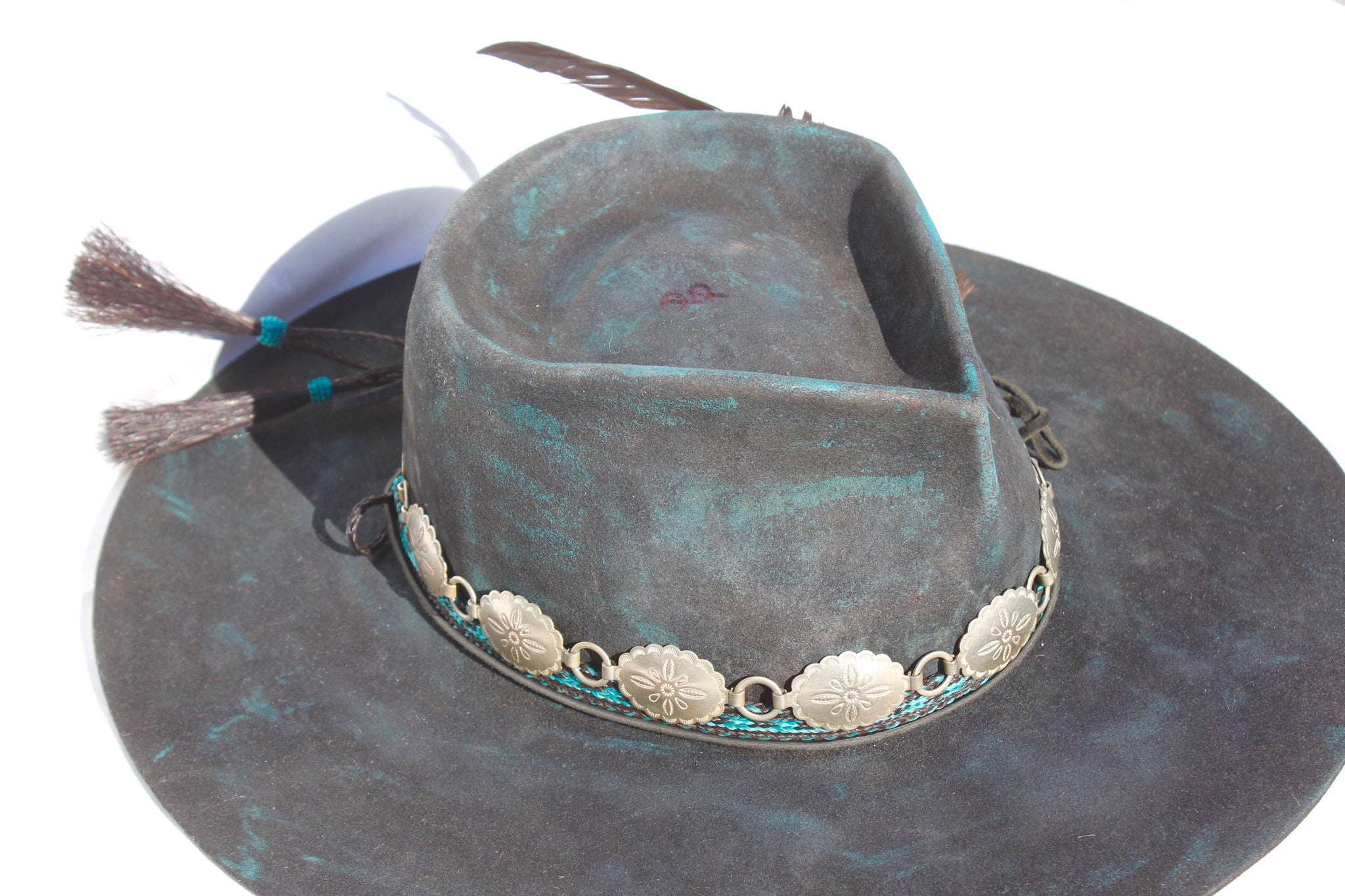 close up top view of the Plum Crazy hat by Lone Hawk Hats featuring hand-dyed purple vintage beaver felt, an open crown, and a hand-beaded floral band.