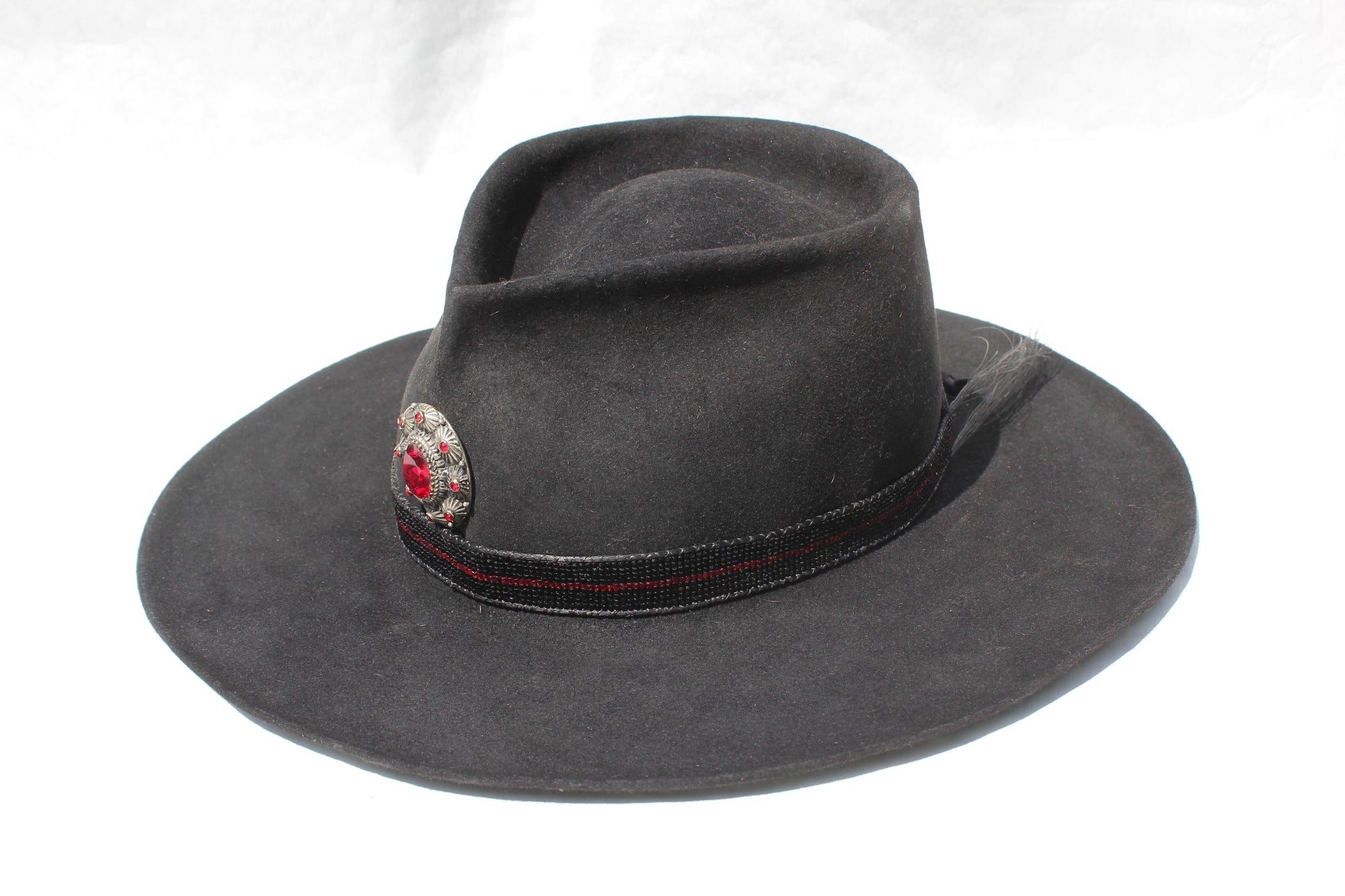 Left view of the The Saturday Night Fever custom Lone Hawk hat, a handmade beaver fur blend western hat featuring a tall tear-drop crown, hand-beaded band with horsehair detail, and antique English medallion.
