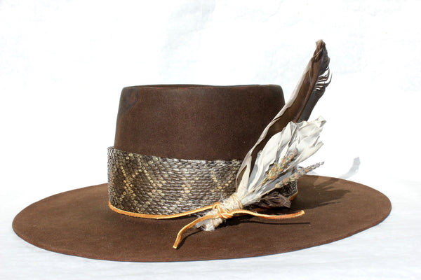 Right view of The Snakebite Telle custom Lone Hawk hat featuring a telescope crown, flat brim, beaver felt body, custom rattlesnake skin band, and found feather accent.