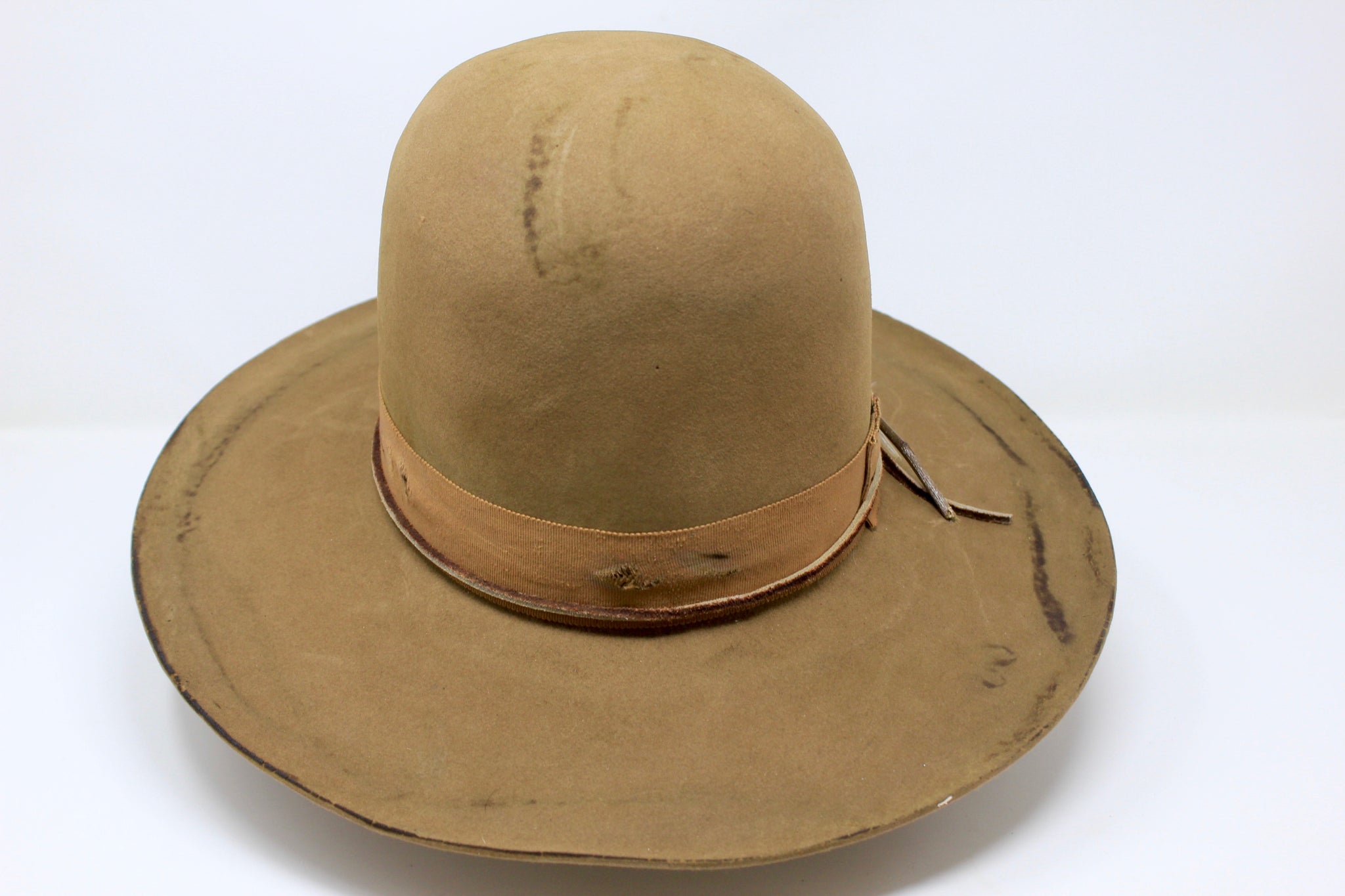 Front view of the Cree Mountain hat by Lone Hawk Hats featuring a tall open crown, flat brim with a slight pencil roll, hand-sewn band, feather accents, and light distressing.