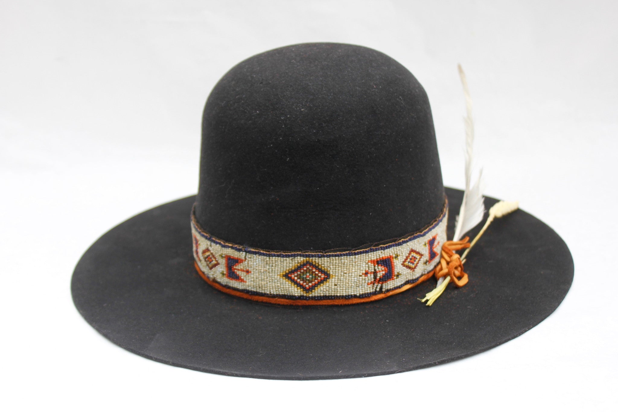 Front view of The Lady Starr by Lone Hawk Hats, a one-of-a-kind open crown western hat featuring an antique Native American hand-beaded band, flat brim, and found feather.